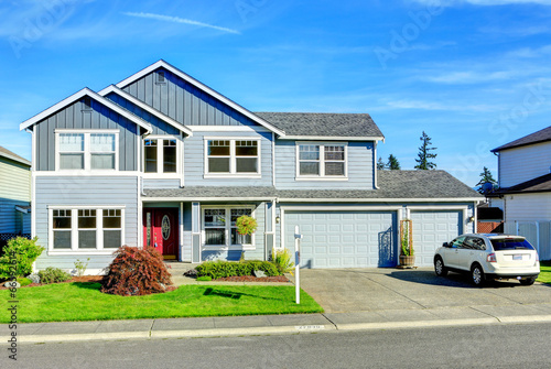 Canvas Print Big two story house. View of entance porch and garage