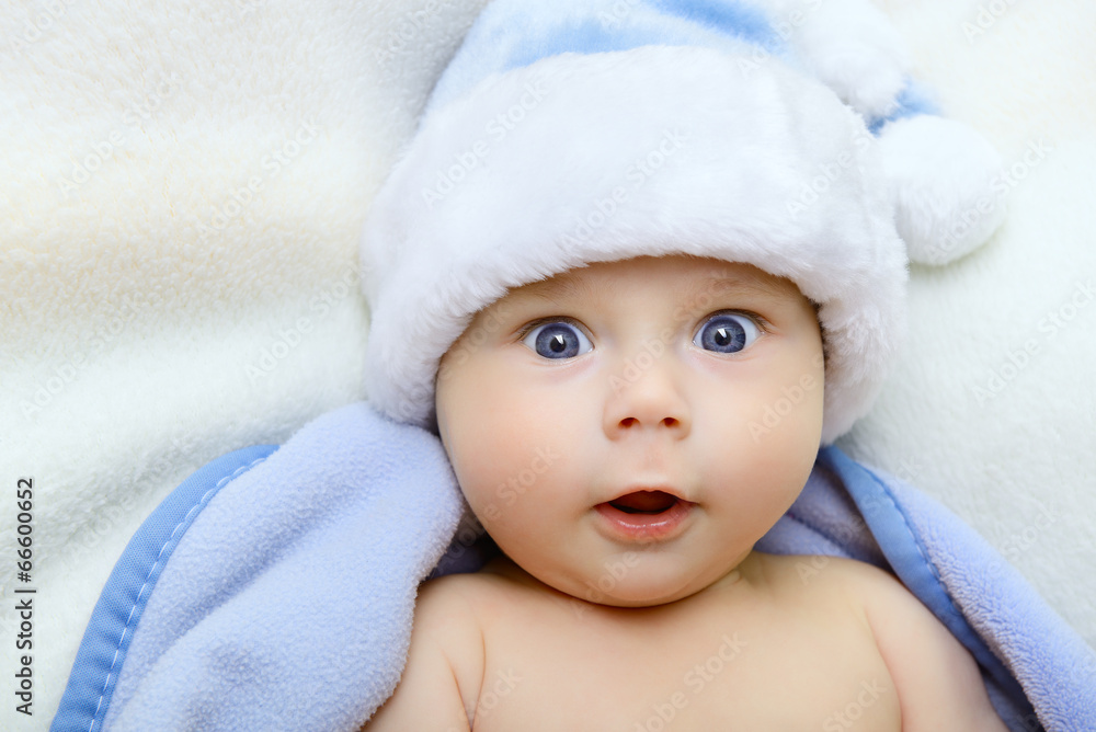 christmas cute baby boy, beautiful infant in Santa's hat and blu christmas cute baby boy, beautiful infant in Santa's hat and blu