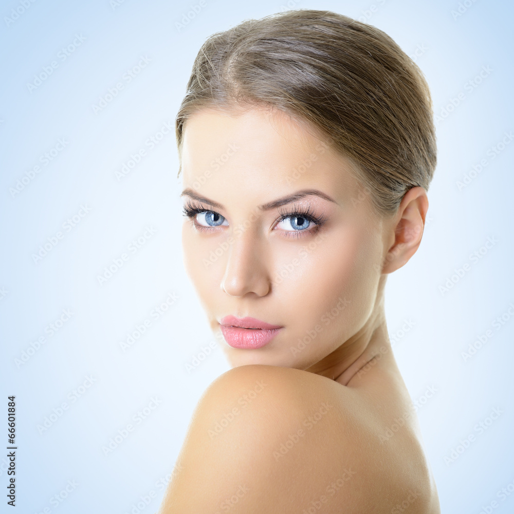 Portrait of attractive young woman over blue Portrait of attractive young woman over blue
