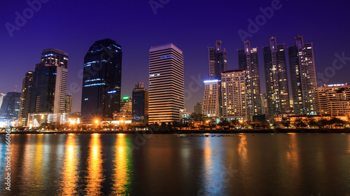 City Downtown at Night with Building Reflection in the River. © Eakkaluk