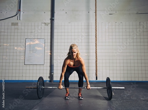 Fit female athlete performing a deadlift