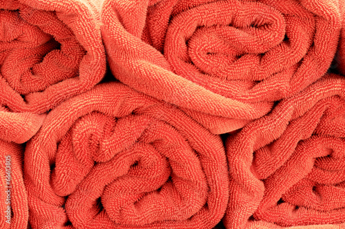 A lot orange towels by the pool.