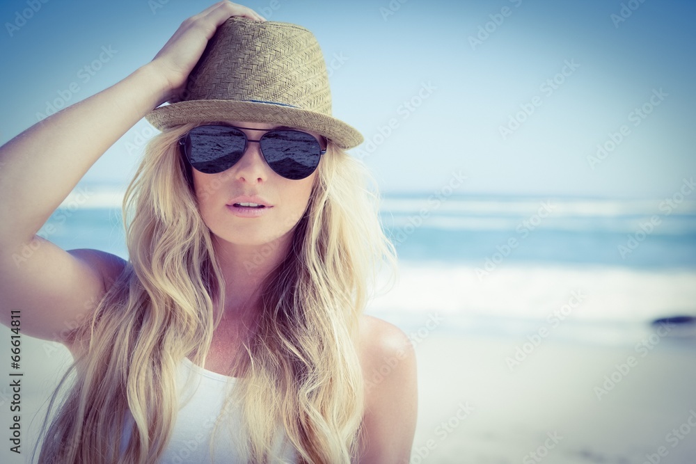 Stylish blonde looking at camera on the beach Stylish blonde looking at camera on the beach