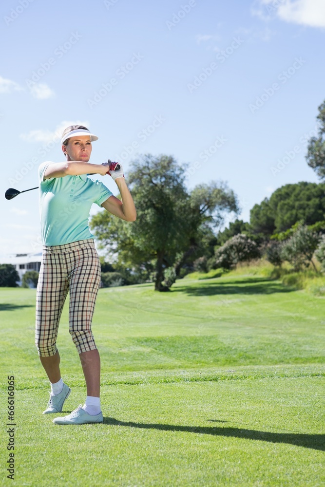 Female golfer taking a shot