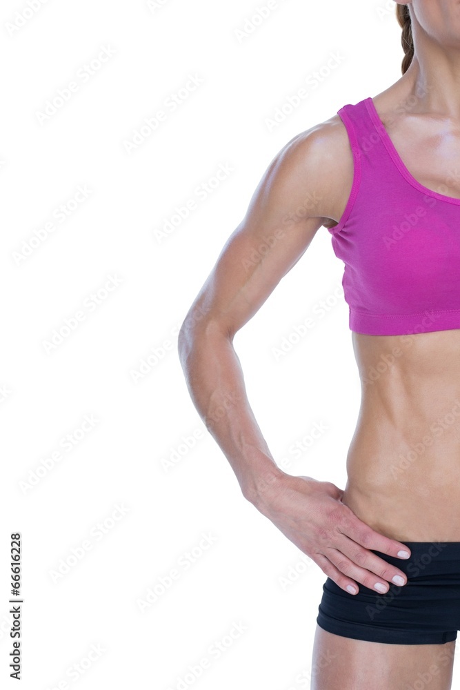 Female bodybuilder posing with hand on hip with copy space Female bodybuilder posing with hand on hip with copy space