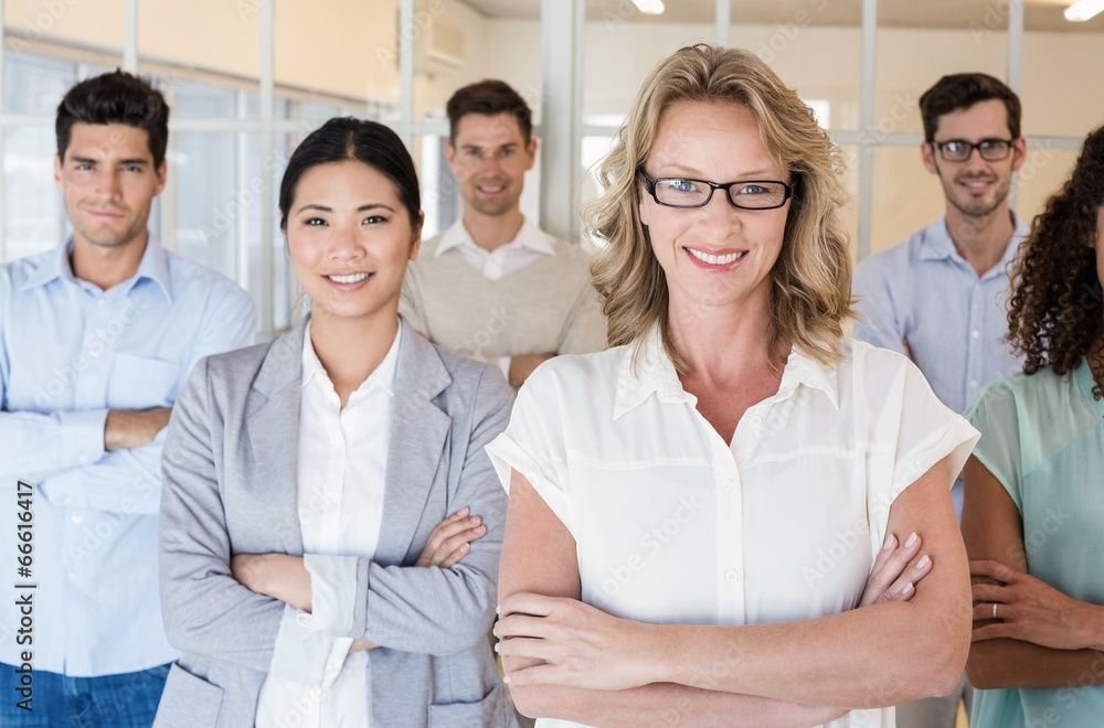 Casual business team smiling at camera with arms crossed Casual business team smiling at camera with arms crossed