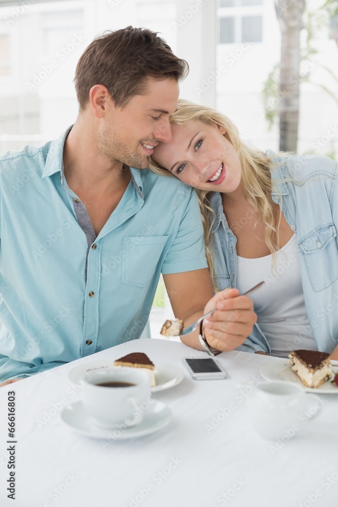 Hip young couple having desert and coffee together Hip young couple having desert and coffee together