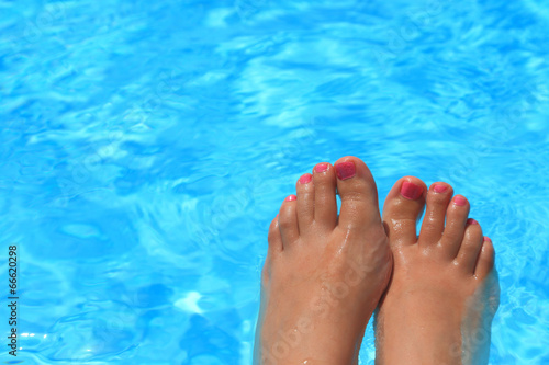 Wet female feet inside water