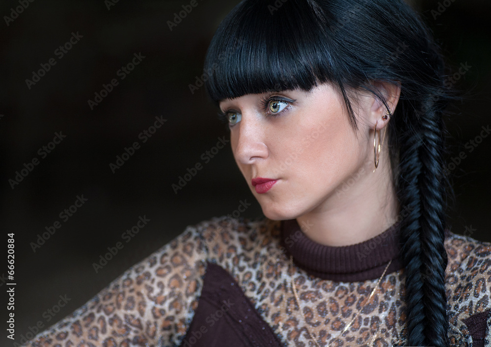 Head and shoulders side view shot of black haired women Head and shoulders side view shot of black haired women