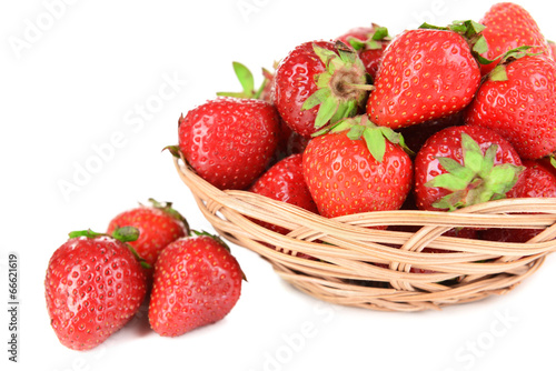 Ripe sweet strawberries in wicker basket isolated on white