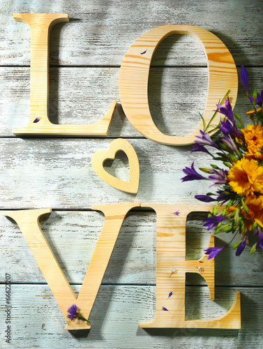 Fototapeta Naklejka Na Ścianę i Meble -  Decorative letters forming word LOVE with wildflowers