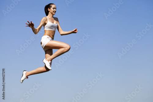 Fototapeta Naklejka Na Ścianę i Meble -  Fitness woman exercising in summer park