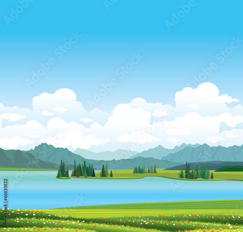 Nature landscape - grass, lake and mountains.