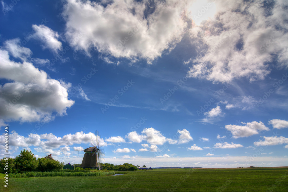 Old windmill against blue sky