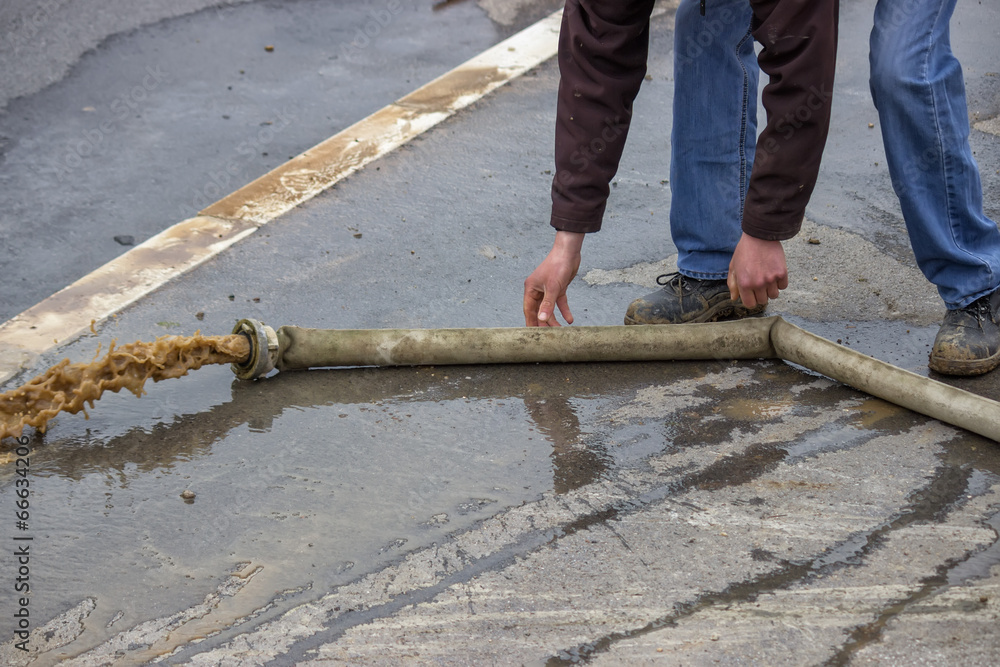 Man pumping away flood water 2 Man pumping away flood water 2