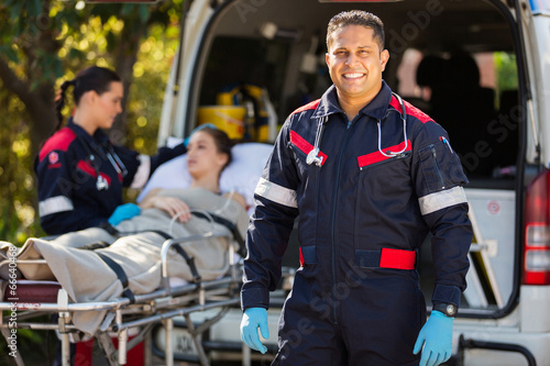 paramedic with colleague and patient on background photo