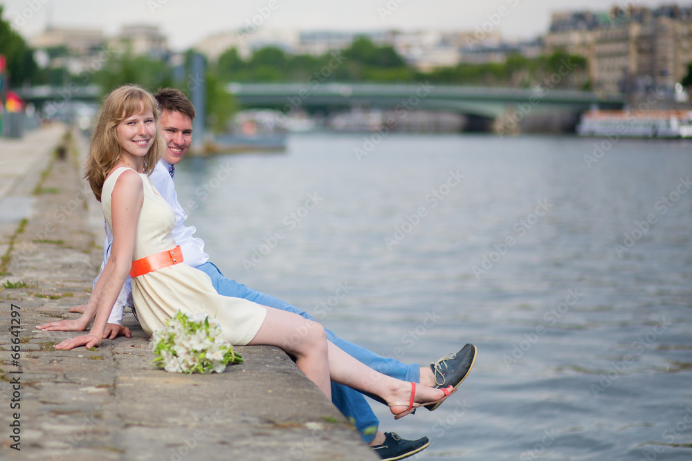 Happy just married couple on the Seine embankment
