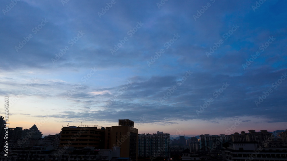 Time lapse of daybreak clouds behind downtown