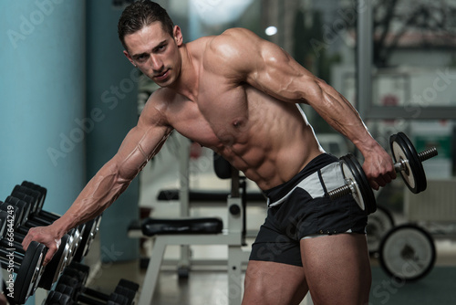 Young Man Exercise With Dumbbells