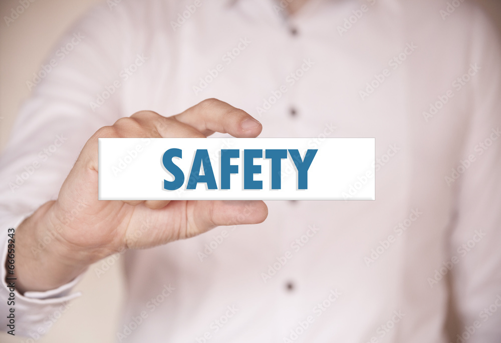 Man holding a word: Safety Man holding a word: Safety