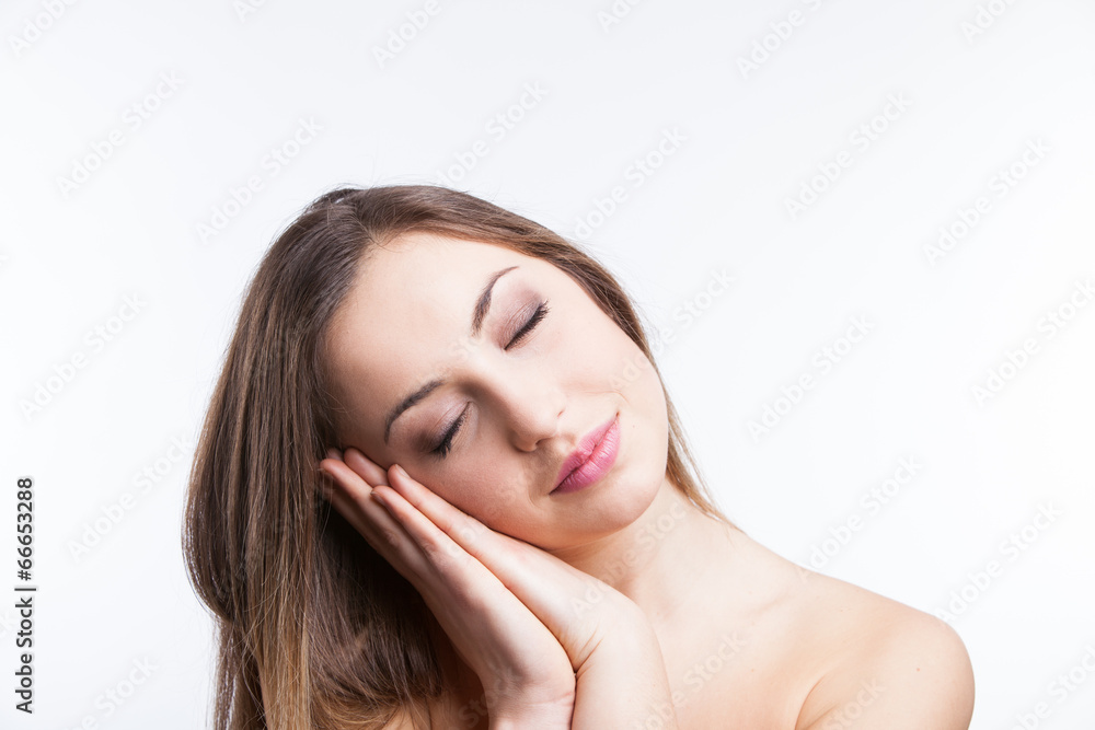 Young girl posing with sleeping gesture Young girl posing with sleeping gesture