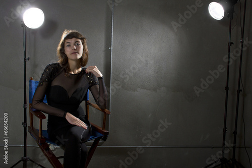 Fotografie, Obraz young female actress sitting on a directors chair