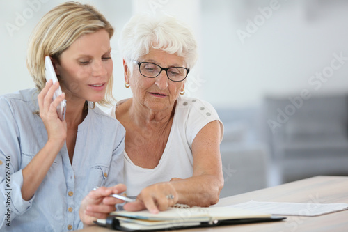 Homehelp booking medical appointment for elderly woman