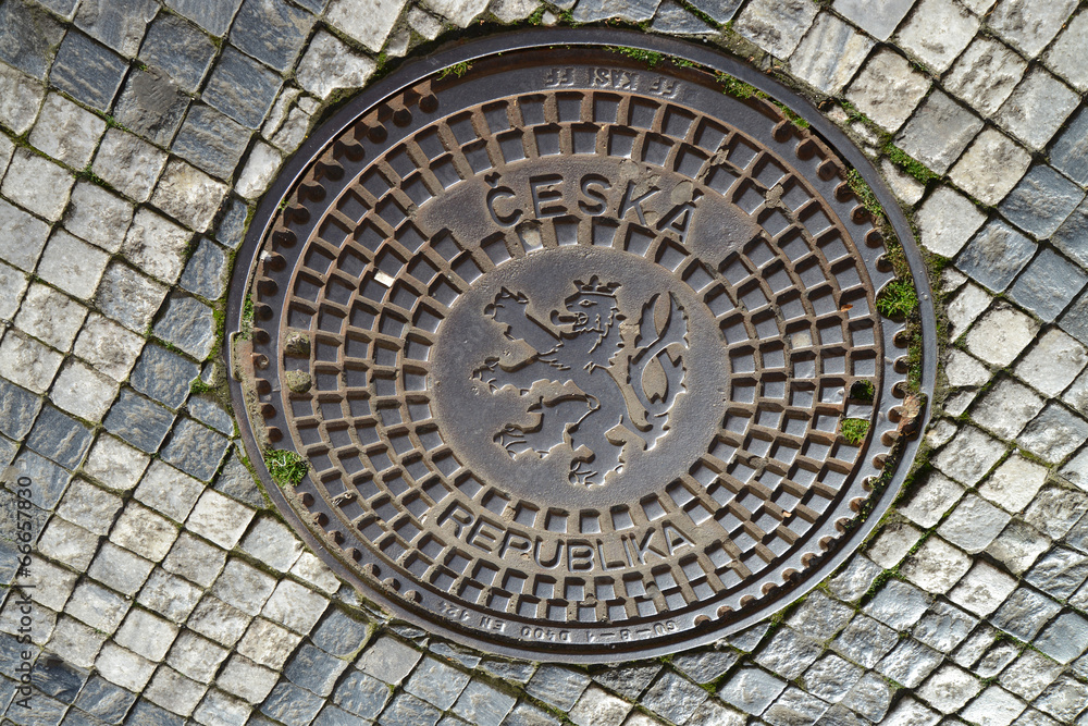 Hatch cover in Prague with the coat of arms of the Czech republi