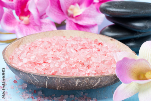 pink sea salt, stones for spa, flowers and towels, close-up