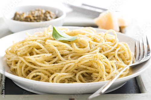 plate of spaghetti with pesto, close-up