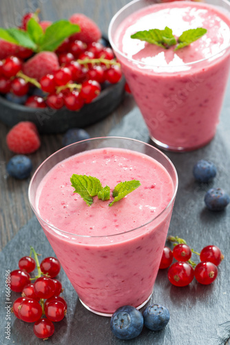 refreshing milkshake with fresh berries and mint in glass