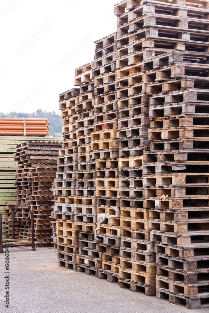 Stacks of old wooden pallets in a yard Stacks of old wooden pallets in a yard
