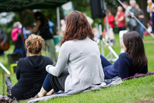 Friends enjoying an outdoors music community event, festival. photo