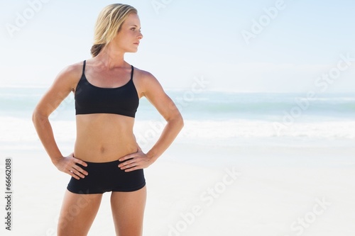 Fit blonde standing on the beach