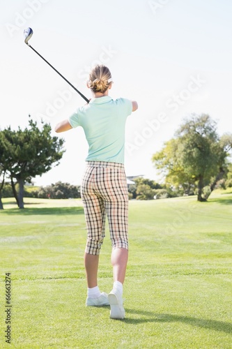 Female golfer taking a shot