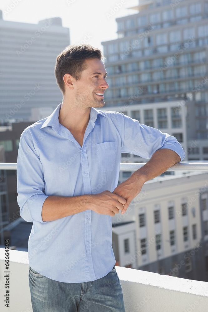 Handsome man looking over on his balcony Handsome man looking over on his balcony