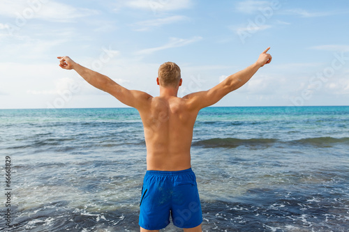 Man in blue swim shorts in the beach © juniart