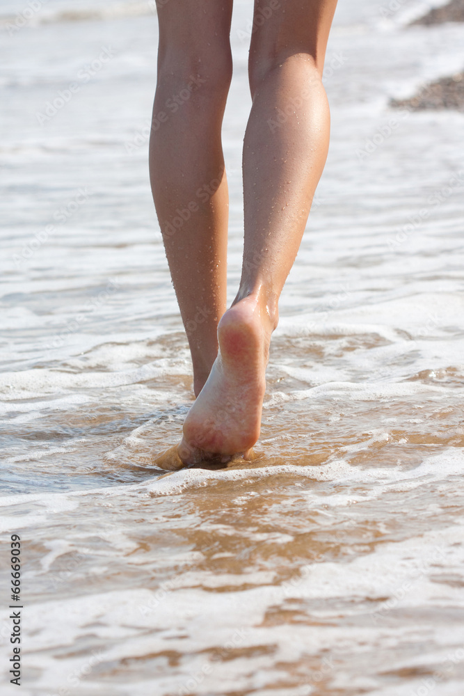 woman walking on the sand beach woman walking on the sand beach