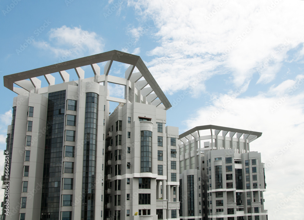 Obraz premium Picture of multiple apartment windows over the sky in Singapore