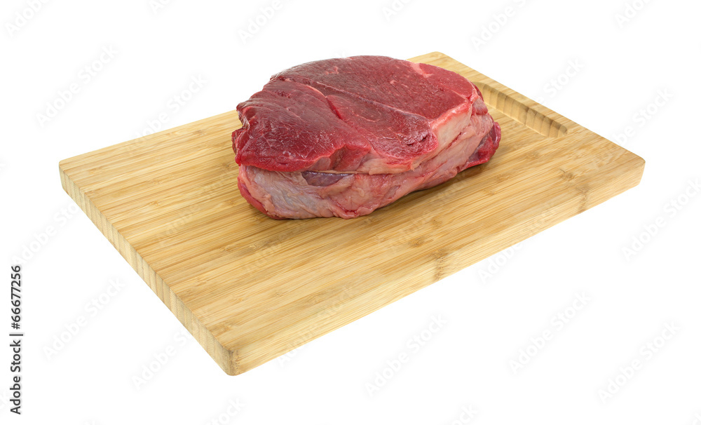 Chuck roast on a wood cutting board Chuck roast on a wood cutting board