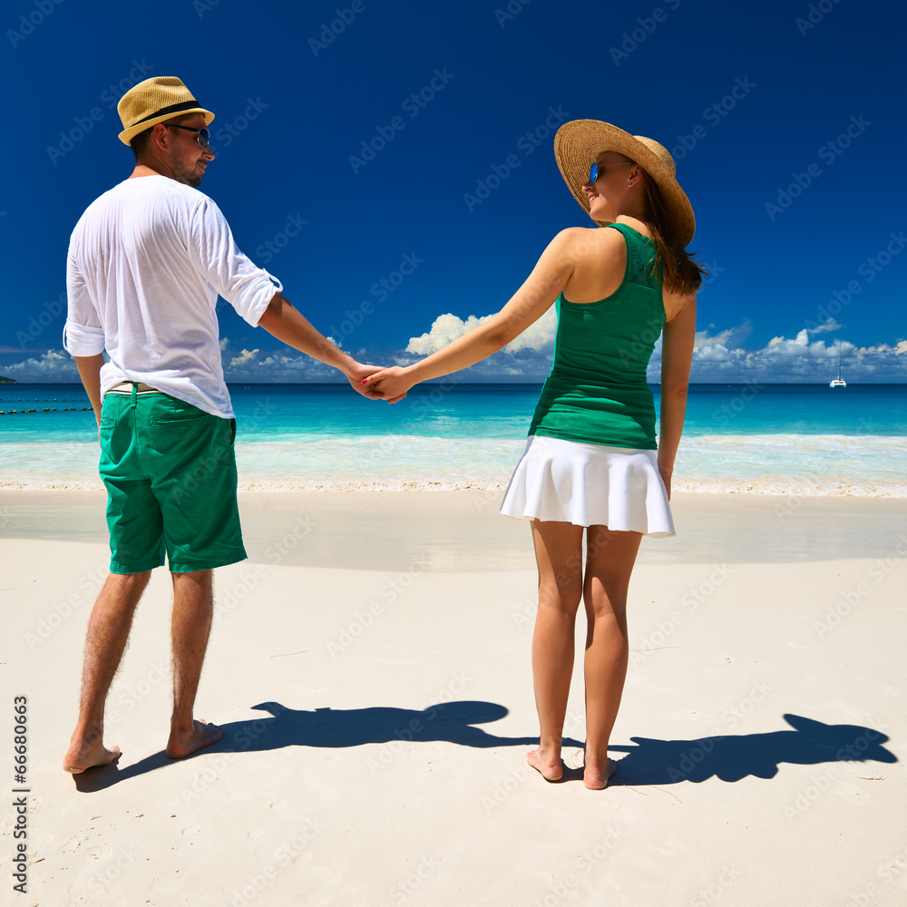 Couple in green on a beach at Seychelles Couple in green on a beach at Seychelles