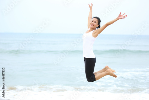 cheering woman jump beach