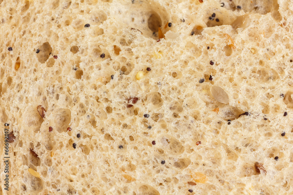 Slice of multi-seed wholegrain bread detail with lots of texture