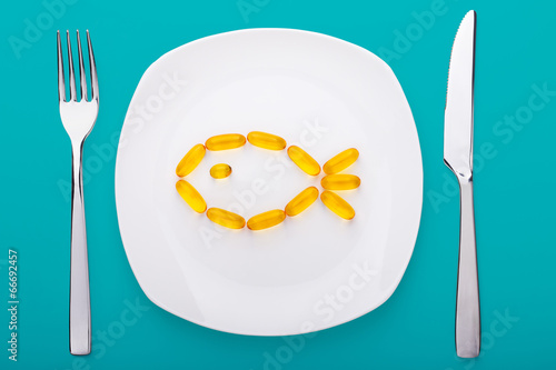 fish oil soft gels lying on a plate