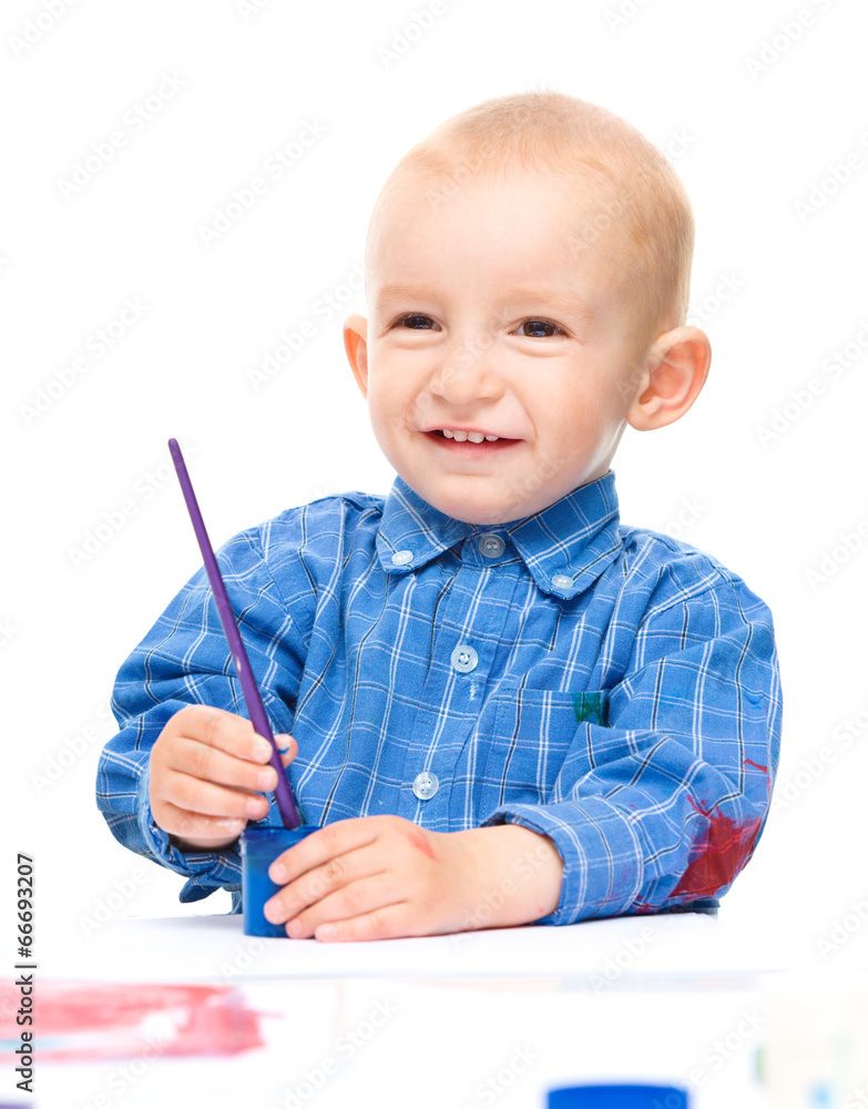 Little boy is playing with paints Little boy is playing with paints