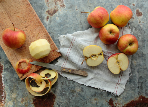 Peel and sliced apples on a kitchen board