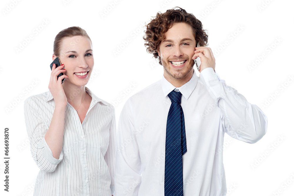 Business people communicating thru mobile phone Business people communicating thru mobile phone