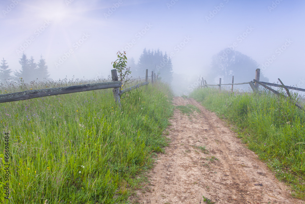 Foggy summer morning in the mountain village.