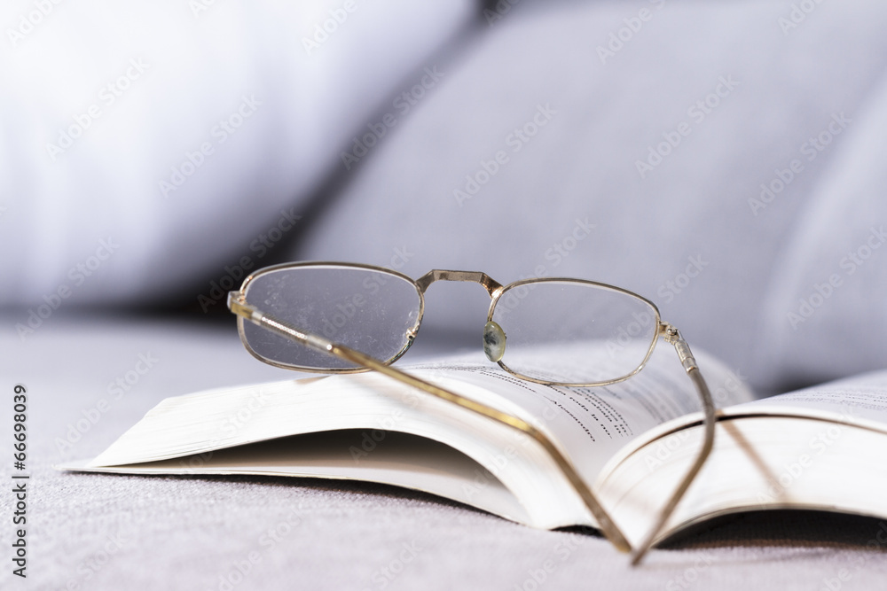 Open book with old glasses