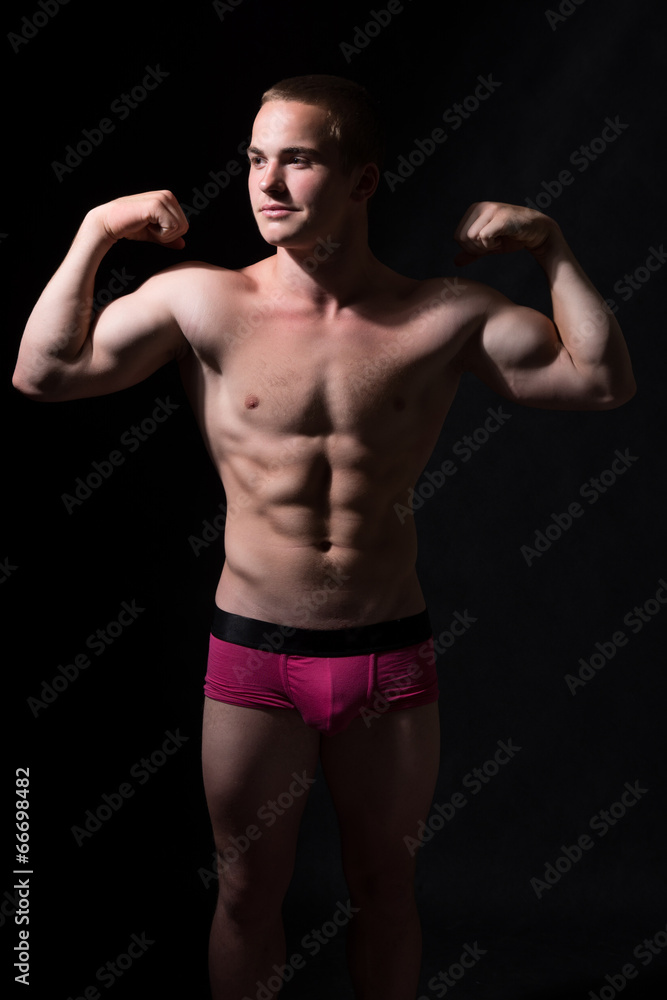 Muscular guy shows biceps.